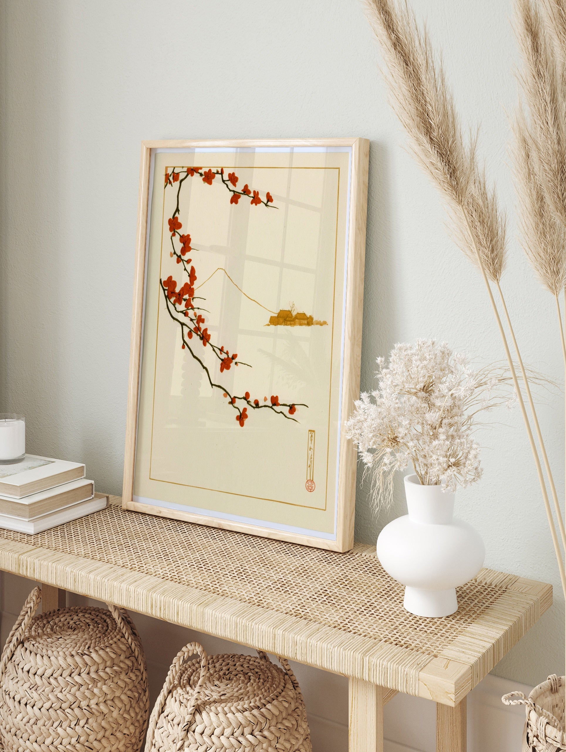 Japanese art print with red plum blossom branch and minimalist Mount Fuji outline on a, in an alternate framed mockup