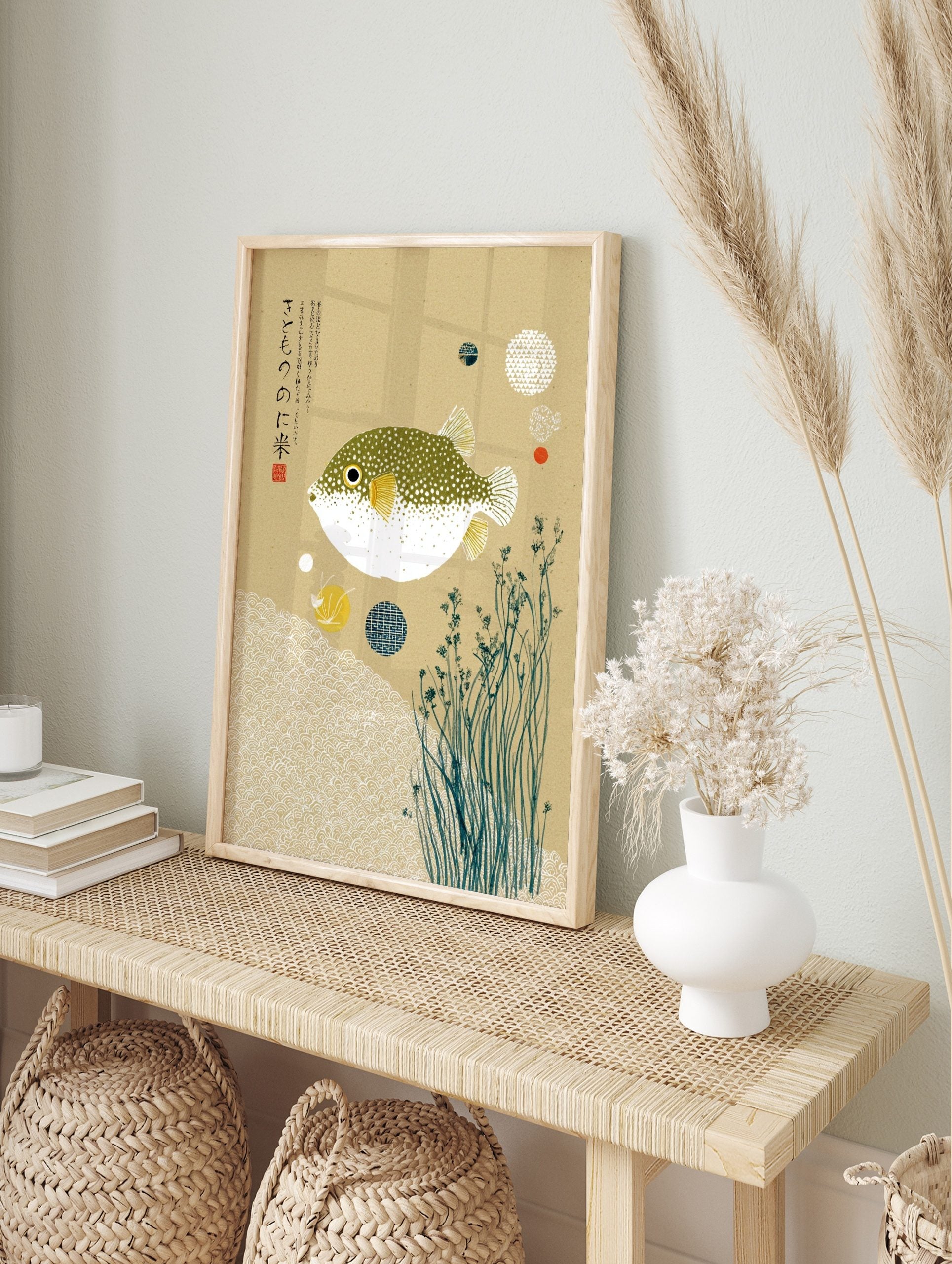 Japanese pufferfish art print with green spotted fugu, yellow fins, white waves, kanji text, in an alternate framed mockup