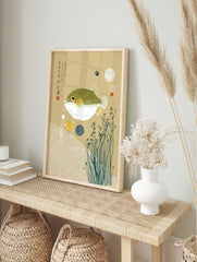 Japanese pufferfish art print with green spotted fugu, yellow fins, white waves, kanji text, in an alternate framed mockup