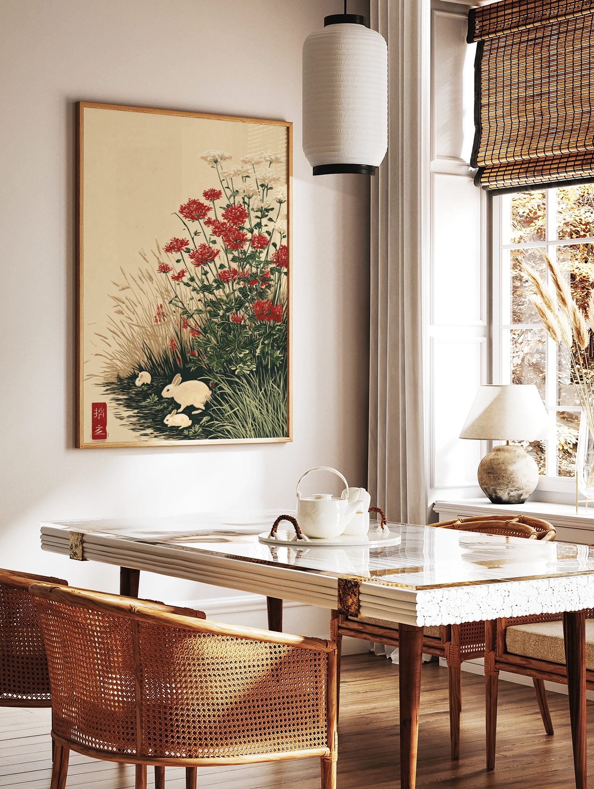 Japanese-style art print with three white rabbits among red and white flowers and tall grasses by, in a styled room mockup