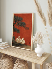 Japanese style illustration of two white rabbits under a pine tree on a red background with an artist's seal. - Image 3