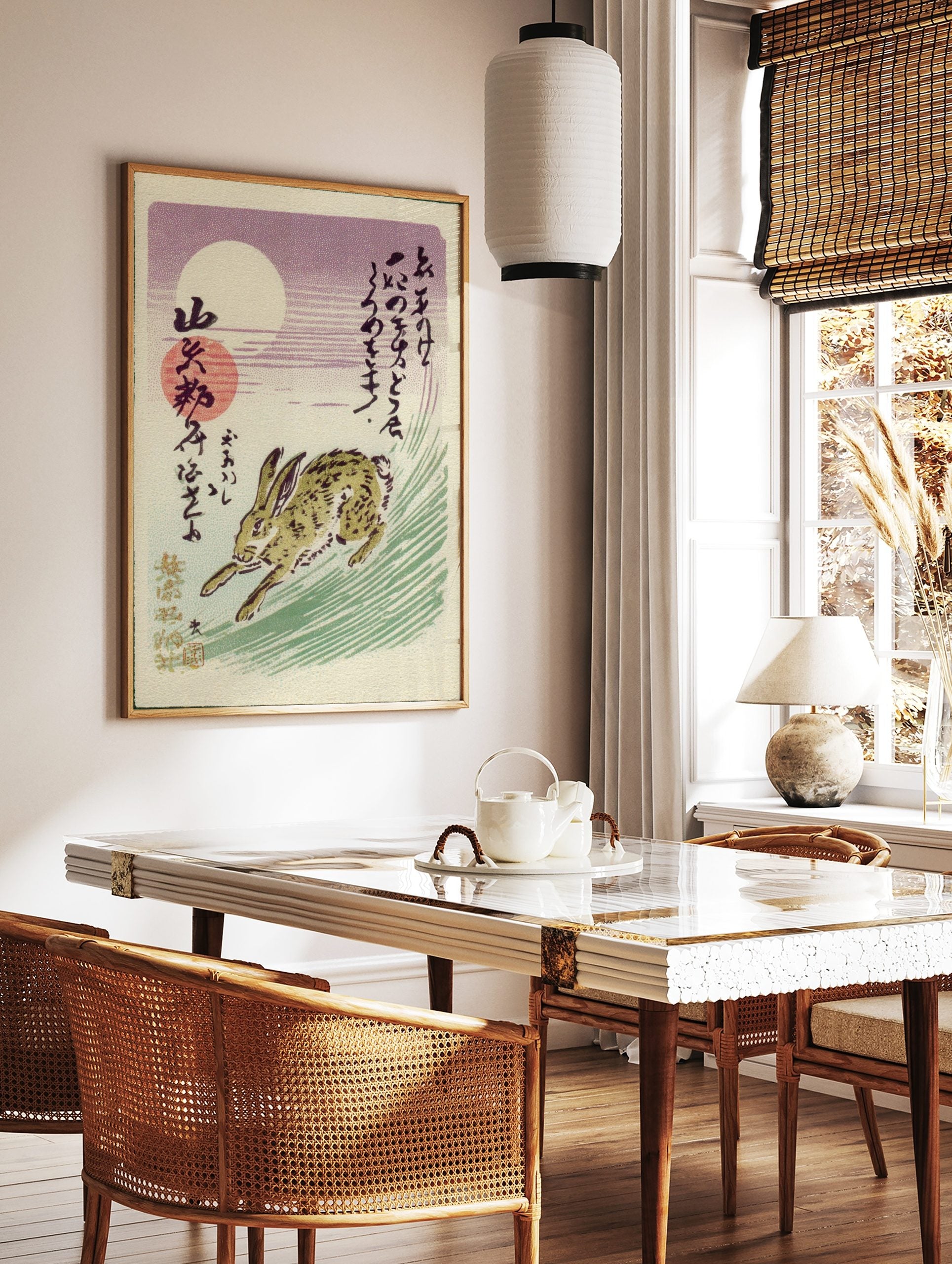 Japanese rabbit running through green grass under a white moon and red sun in a purple sky, with, in a styled room mockup