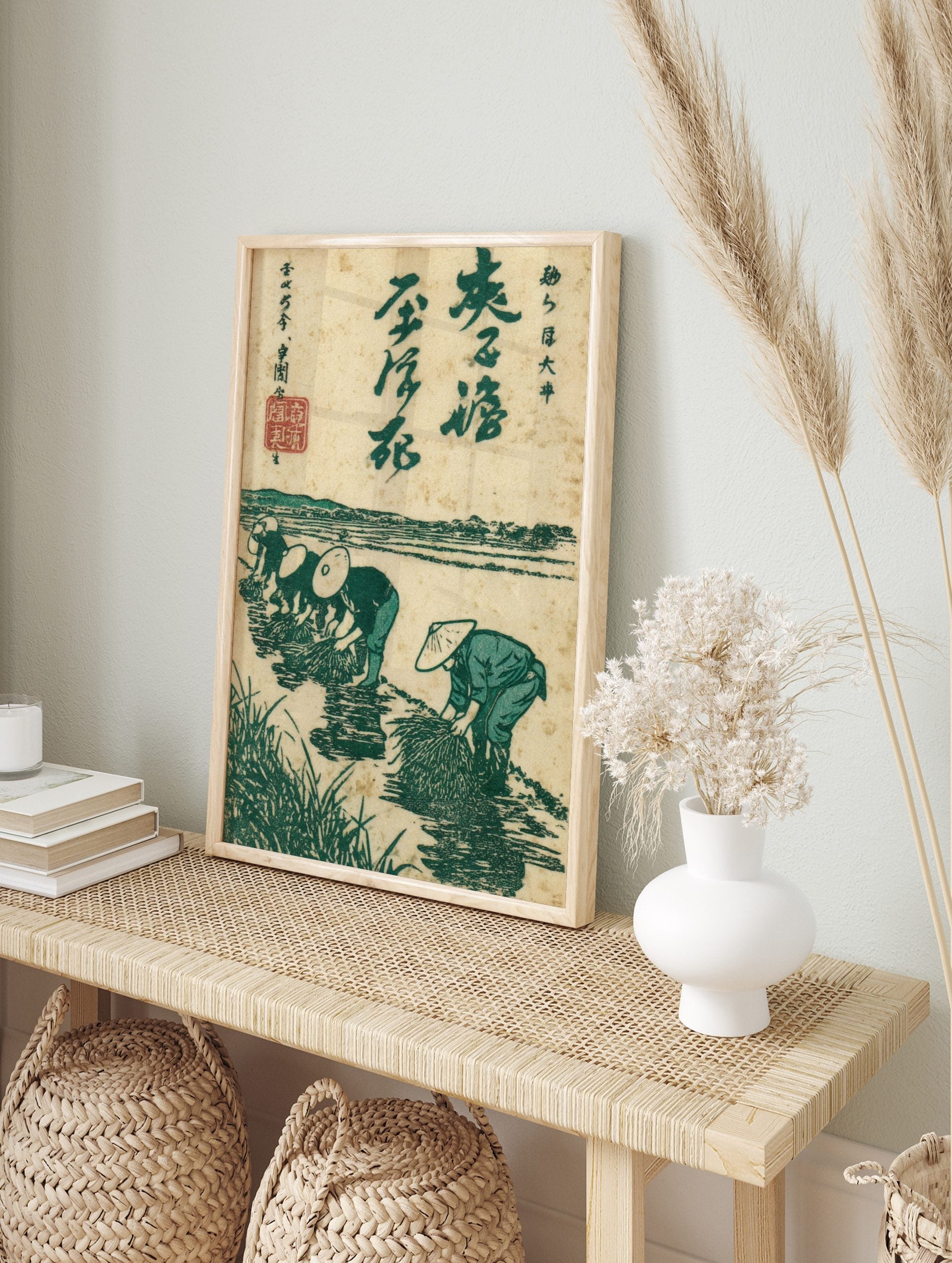 Japanese woodblock print showing four rice planters in a green paddy field with distant hills, in an alternate framed mockup
