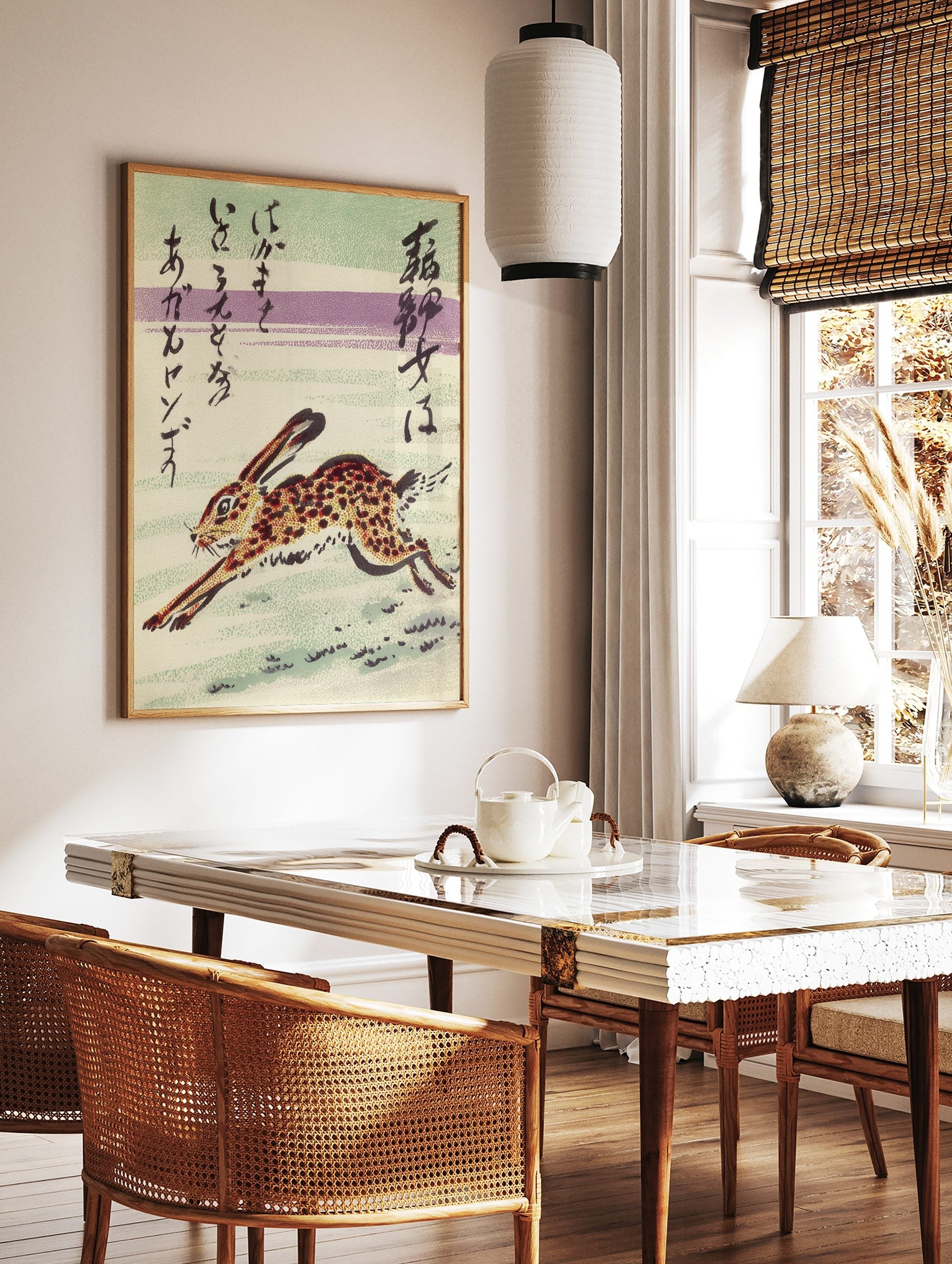 Japanese art print of a spotted running rabbit with calligraphic text on a striped green and purple, in a styled room mockup