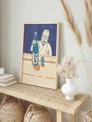 Japanese man in traditional attire holding a sake bottle and presenting it, with a patterned, in an alternate framed mockup