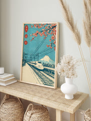 Japanese woodblock-style print of Shinkansen bullet train, Mount Fuji, and red cherry, in an alternate framed mockup