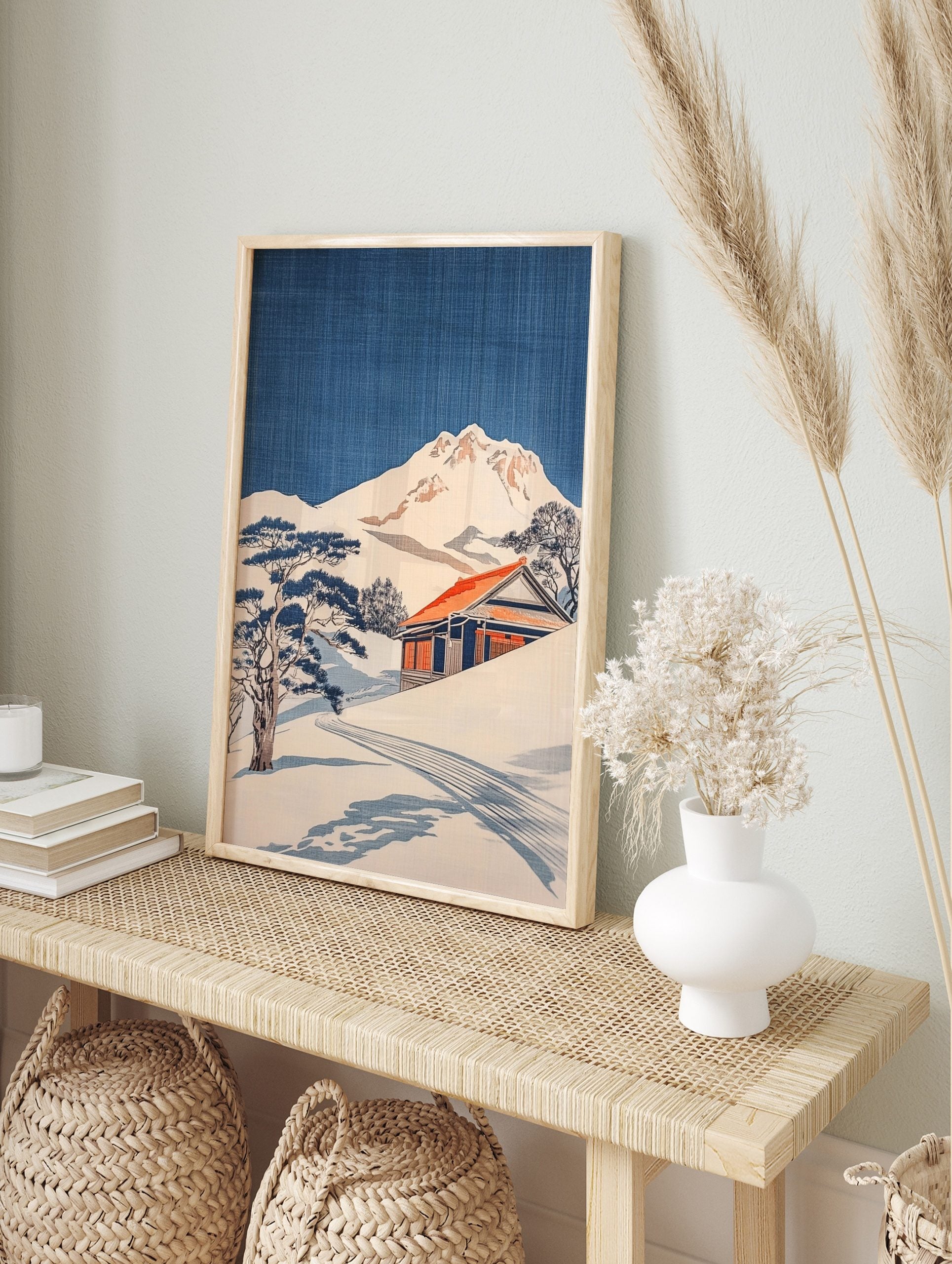 Japanese woodblock style print of a snowy mountain, traditional house with red roof, and pine, in an alternate framed mockup