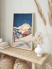 Japanese woodblock style print of a snowy mountain, traditional house with red roof, and pine, in an alternate framed mockup