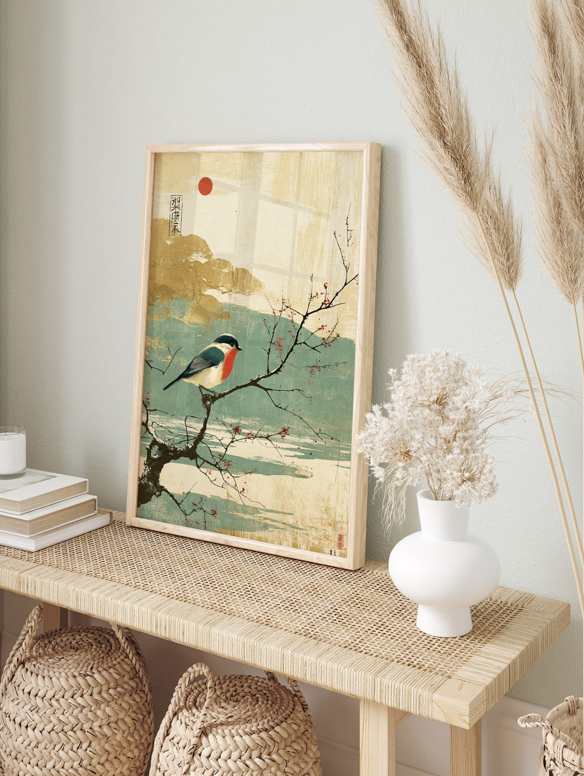 Japanese style print of a red-breasted bullfinch on a snowy branch with red berries and a red, in an alternate framed mockup