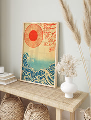 Japanese illustration with red sun, cherry blossom branches, and blue ocean waves on a beige, in an alternate framed mockup