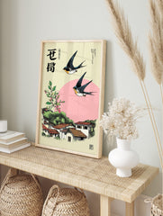Japanese swallows flying over a village with terracotta roofs, pink berries, green foliage, in an alternate framed mockup