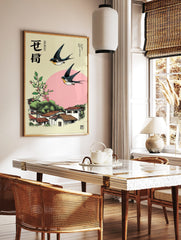 Japanese swallows flying over a village with terracotta roofs, pink berries, green foliage, and, in a styled room mockup
