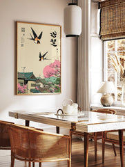 Japanese Ukiyo-e style art print with two swallows flying over a village with cherry blossoms and a, in a styled room mockup