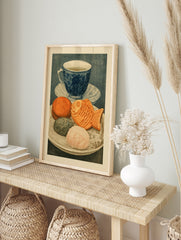 Illustrative art print of a blue tea cup and a plate of Japanese sweets including a, in an alternate framed mockup