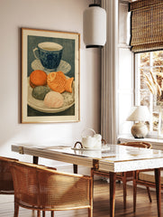 Illustrative art print of a blue tea cup and a plate of Japanese sweets including a fish-shaped, in a styled room mockup