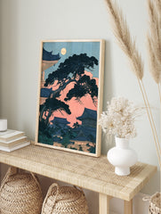 Japanese pagoda and pine tree illustration under a full moon with pink sky and blue, in an alternate framed mockup