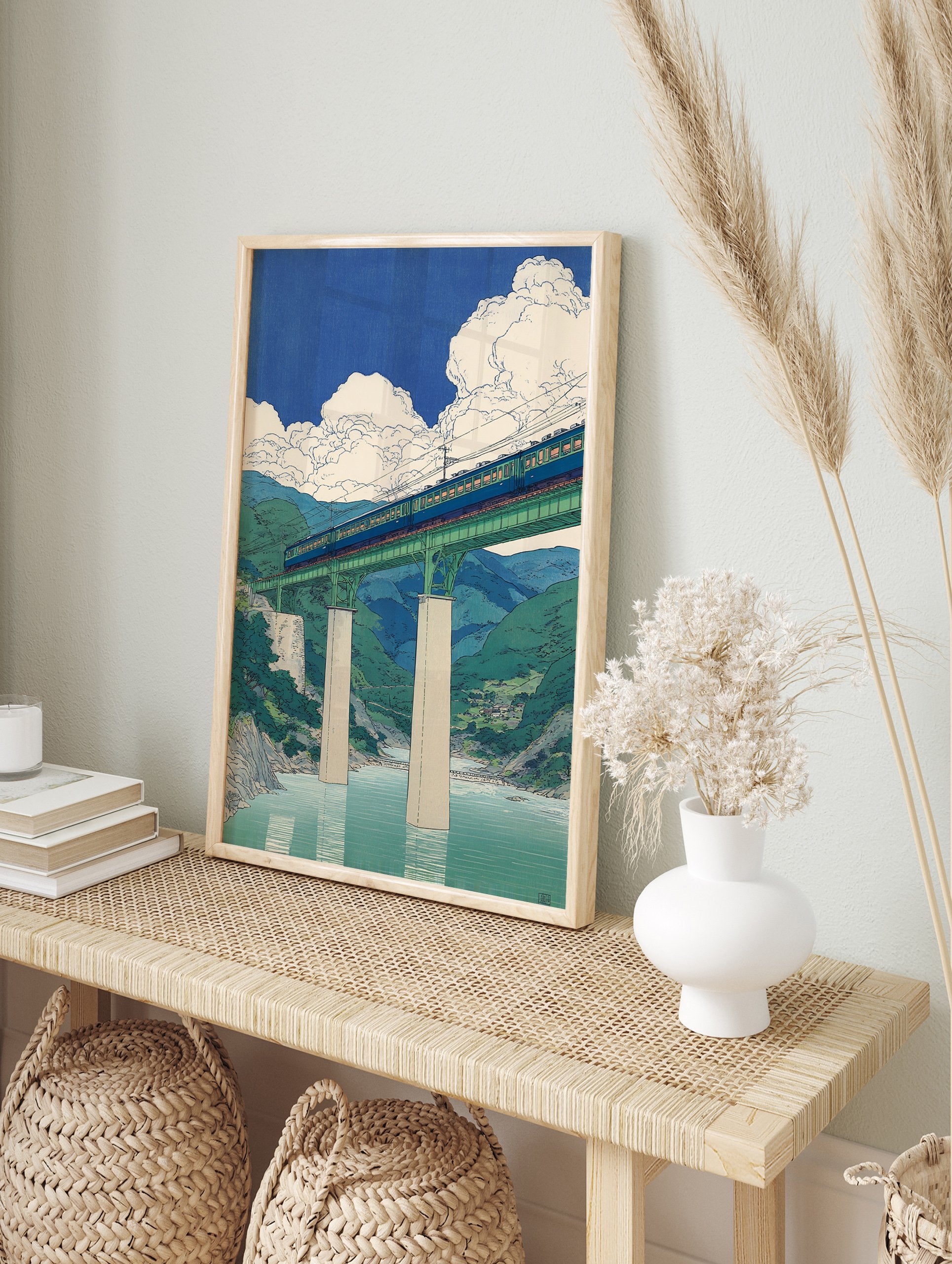 Japanese style art print of a blue train crossing a green bridge over a river with mountains and clouds in blue sky. - Image 3