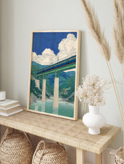 Japanese style art print of a blue train crossing a green bridge over a river with mountains and clouds in blue sky. - Image 3