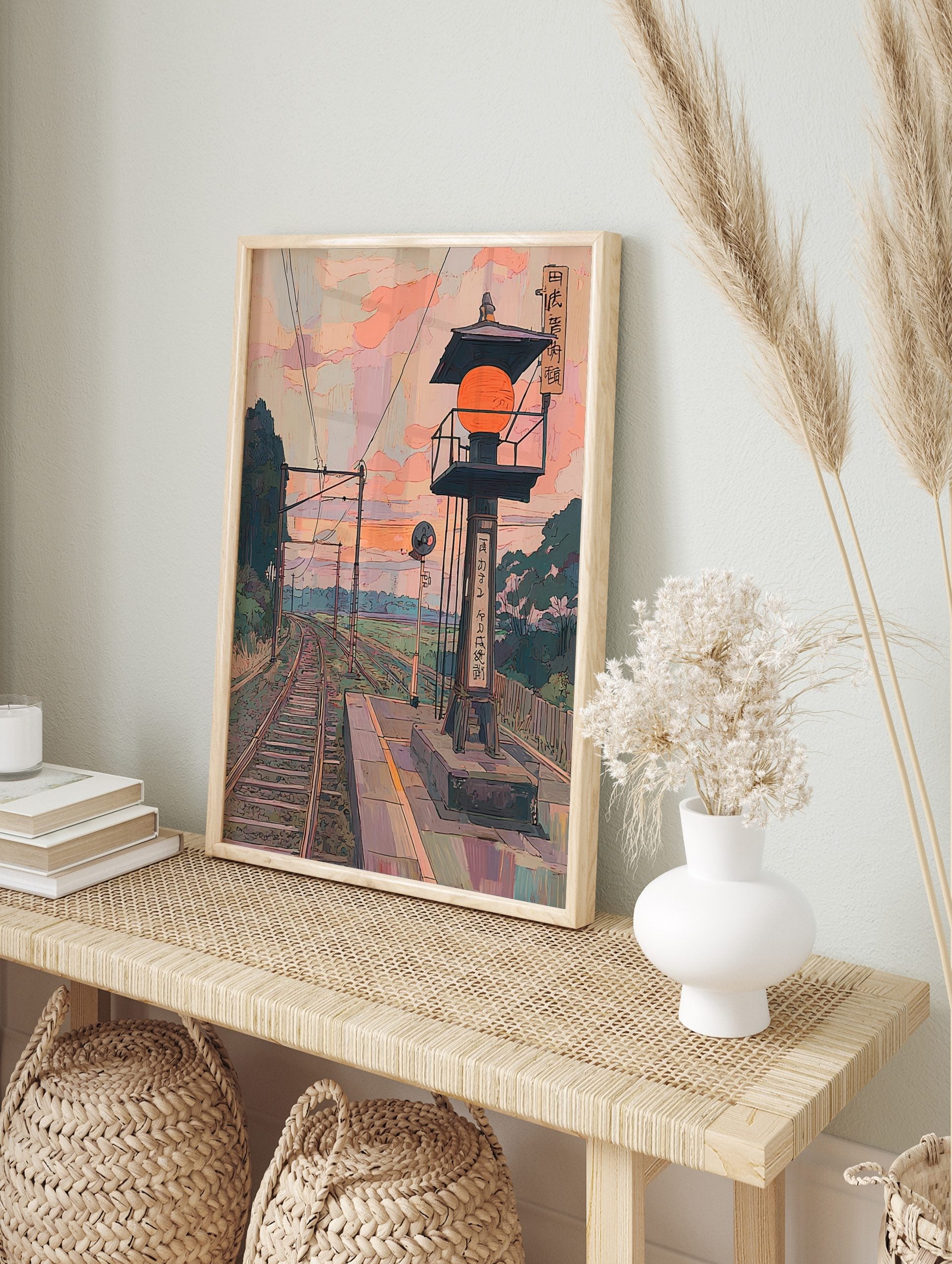 Japanese train station platform with orange lantern, curving railway tracks, and pastel sky, in an alternate framed mockup