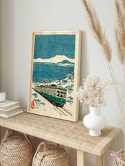 Japanese Train Wall Art woodblock print featuring a green train on tracks by a snowy blue sea and distant mountains. - Image 3