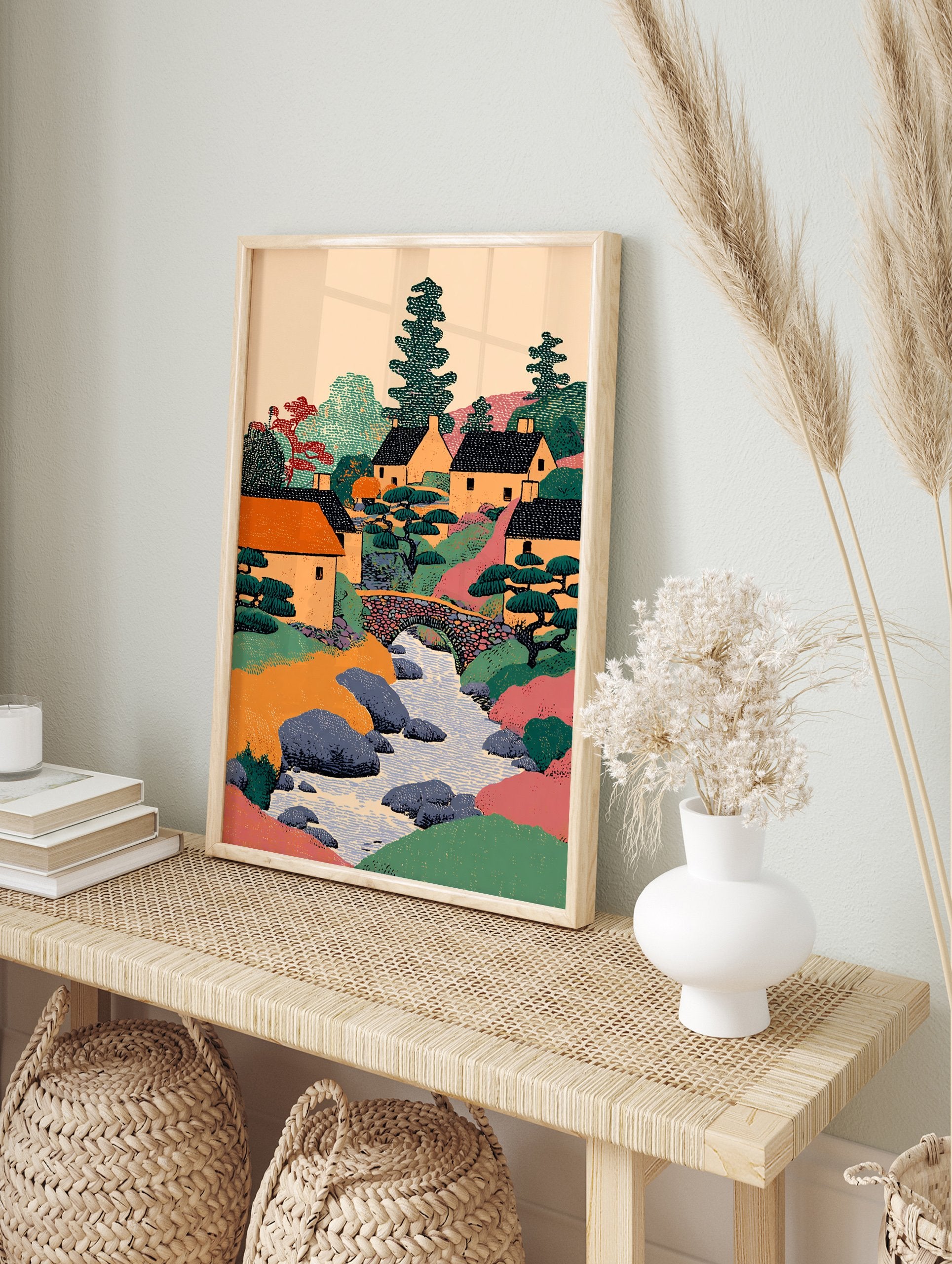 Illustrative Japanese village wall art showing houses, a river, stone bridge, and trees in a colorful landscape print. - Image 3