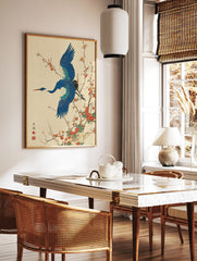 Japanese Wall Art print of a blue crane bird flying among red plum blossoms on a textured cream background. - Image 2