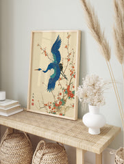 Japanese Wall Art print of a blue crane bird flying among red plum blossoms on a textured cream background. - Image 3
