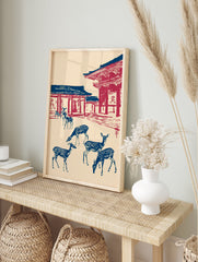 Japanese Wall Art print of blue deer with white spots in front of red and blue temple architecture on a cream background. - Image 3