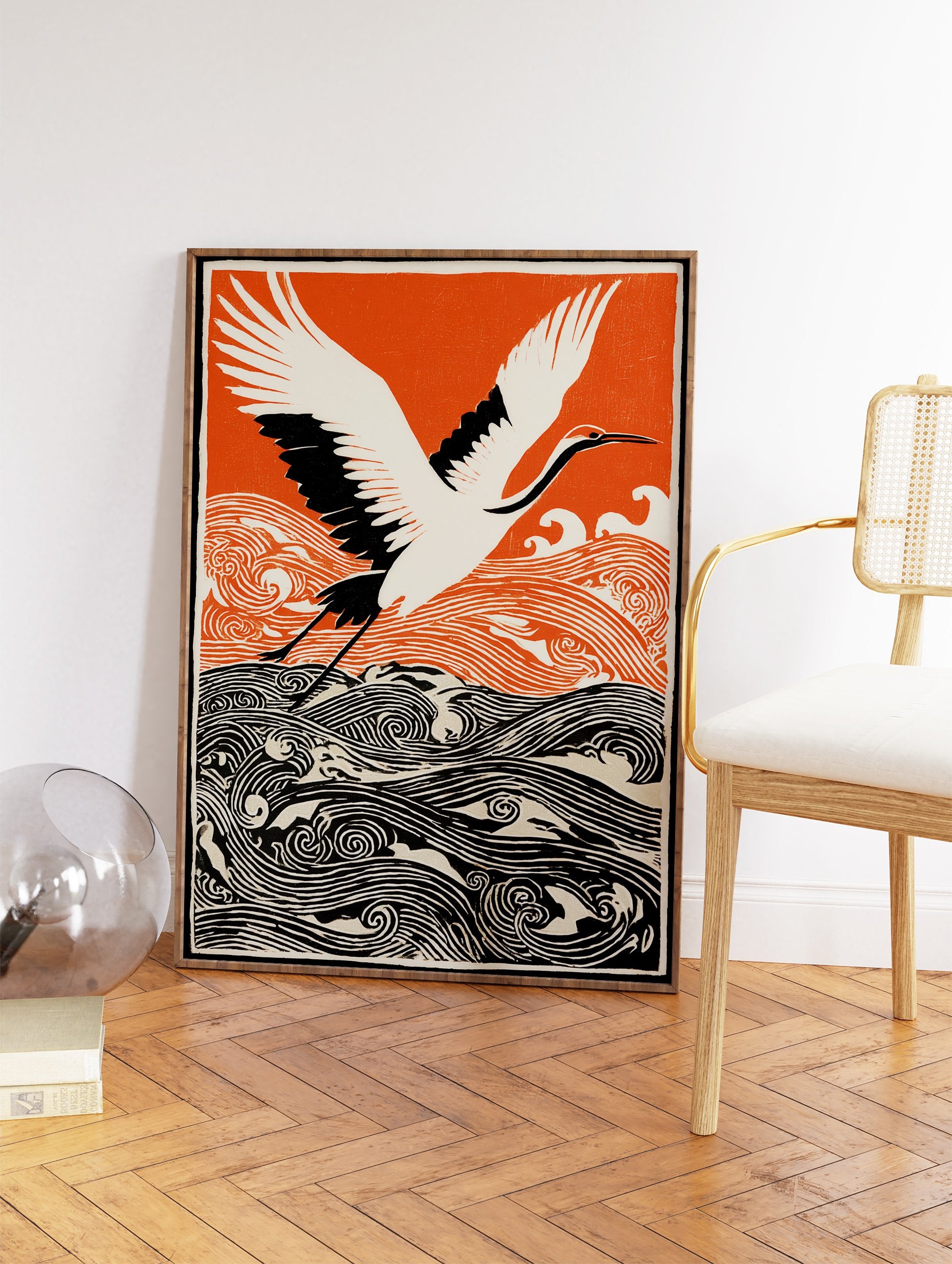 Japanese wall art print of a white and black crane flying over orange and black stylized waves against an orange sky. - Image 2