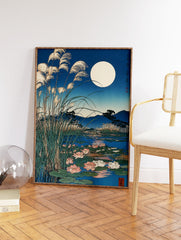 Japanese Wall Art print of a full moon over a pond with water lilies, tall reeds, and mountains in blue night tones. - Image 2