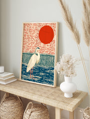 Japanese wall art print of a white heron bird in a blue pond with green reeds and a red sun against a peach sky. - Image 3