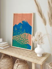 Japanese wall art depicting Mount Fuji, an orange sky, and lush green botanical plants with small white flowers in the foreground. - Image 3