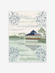 Japanese Wall Art featuring a serene pagoda on a lake with reflections, surrounded by green hills and blue botanical branches.
