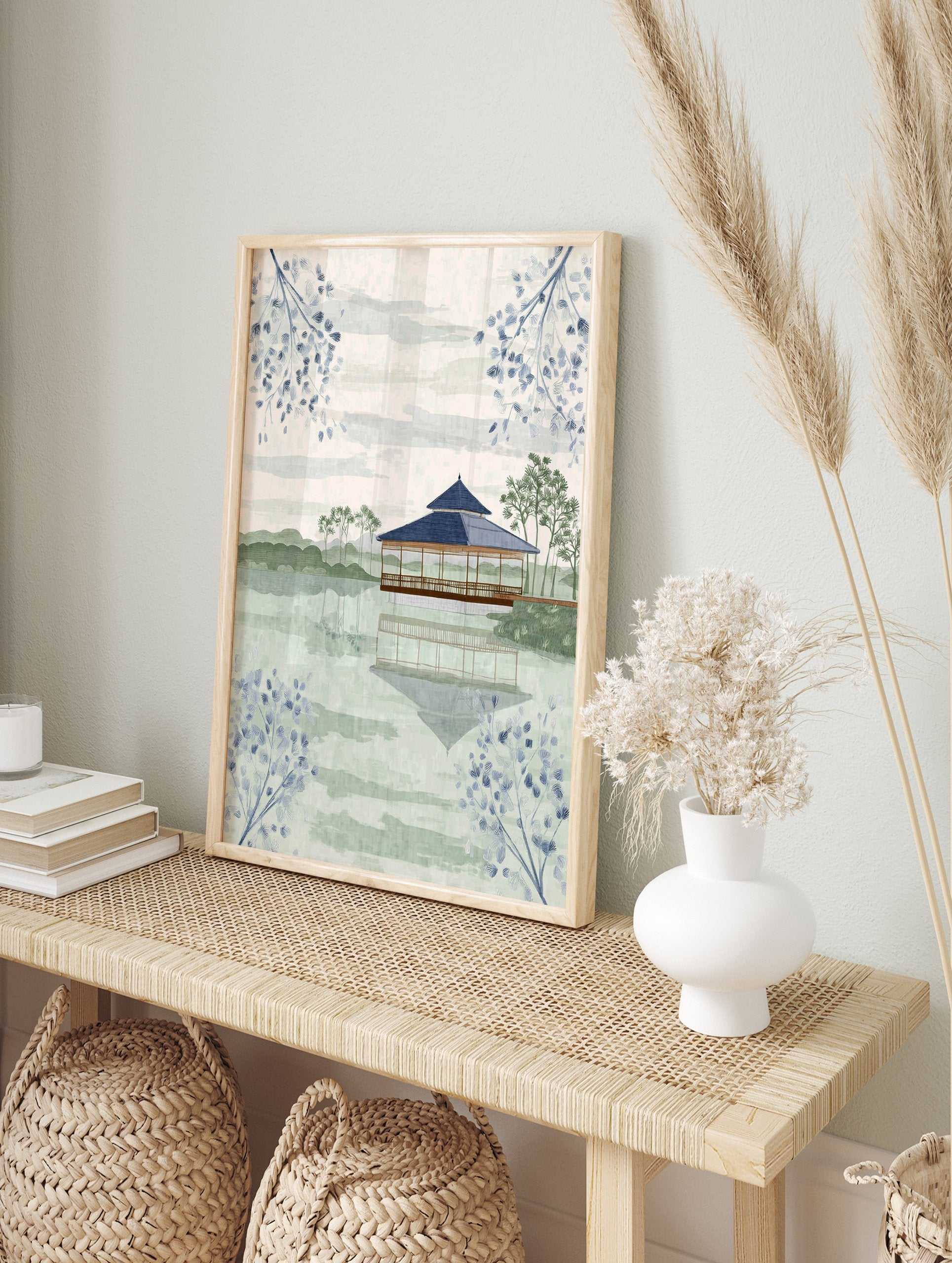 Japanese Wall Art featuring a serene pagoda on a lake with reflections, surrounded by green hills and blue botanical branches. - Image 3