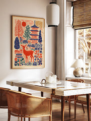 Japanese wall art print featuring a red deer, blue pagodas, red sun, and folk art trees and flowers on a cream background. - Image 2