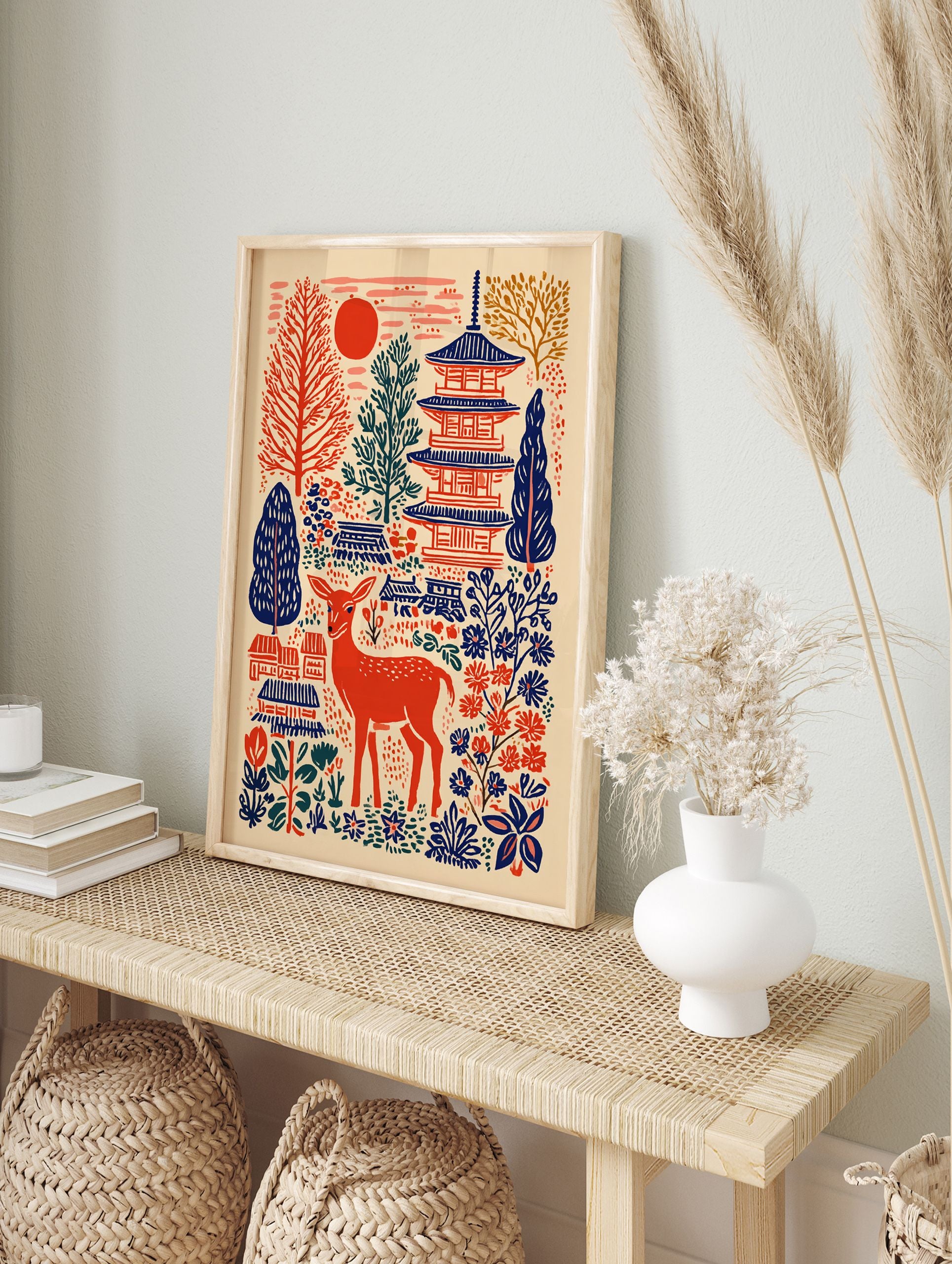 Japanese wall art print featuring a red deer, blue pagodas, red sun, and folk art trees and flowers on a cream background. - Image 3