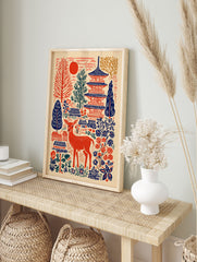 Japanese wall art print featuring a red deer, blue pagodas, red sun, and folk art trees and flowers on a cream background. - Image 3