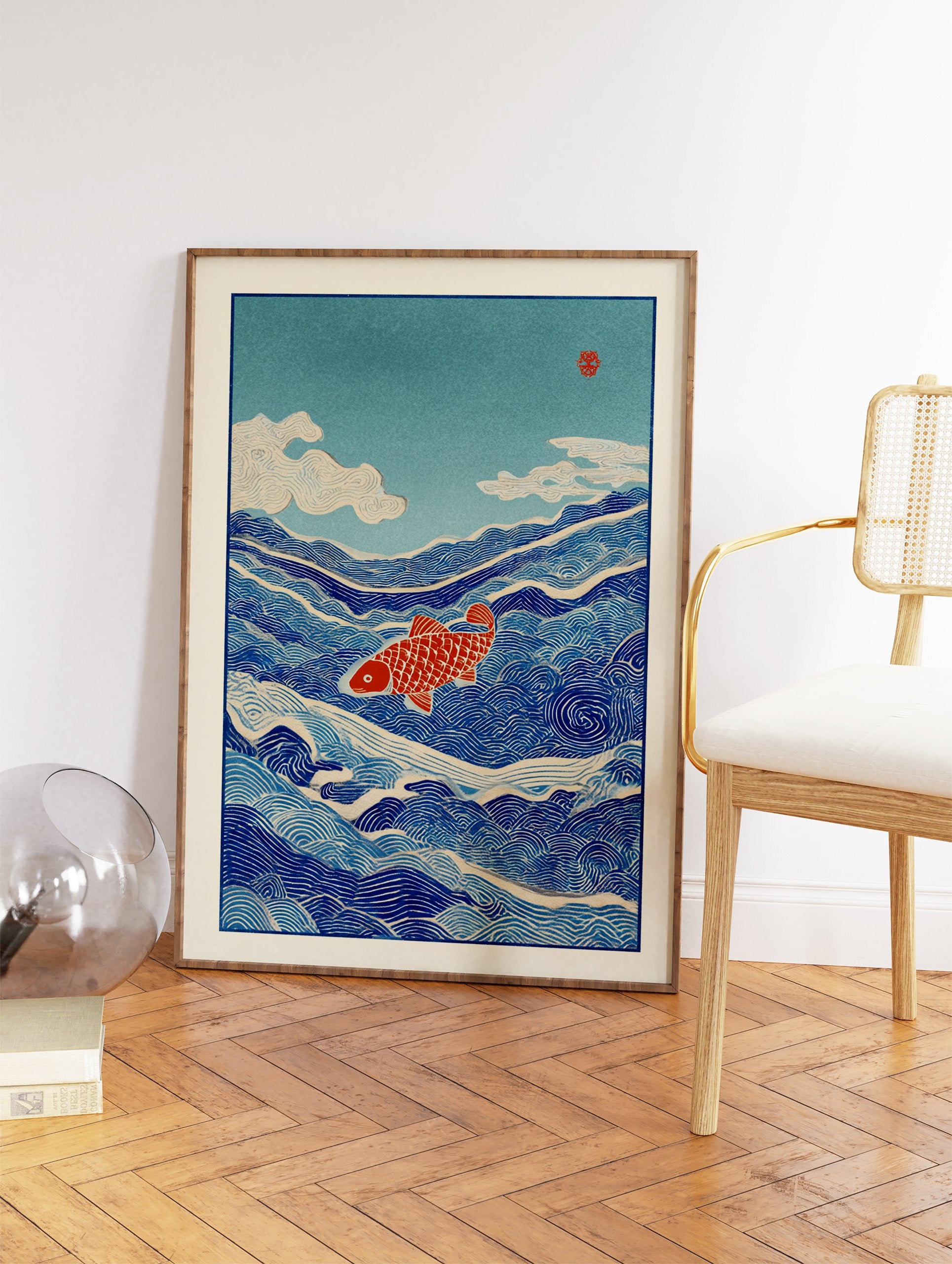 Japanese wall art print depicting a red fish swimming through blue ocean waves with clouds and a red stamp in the sky. - Image 2