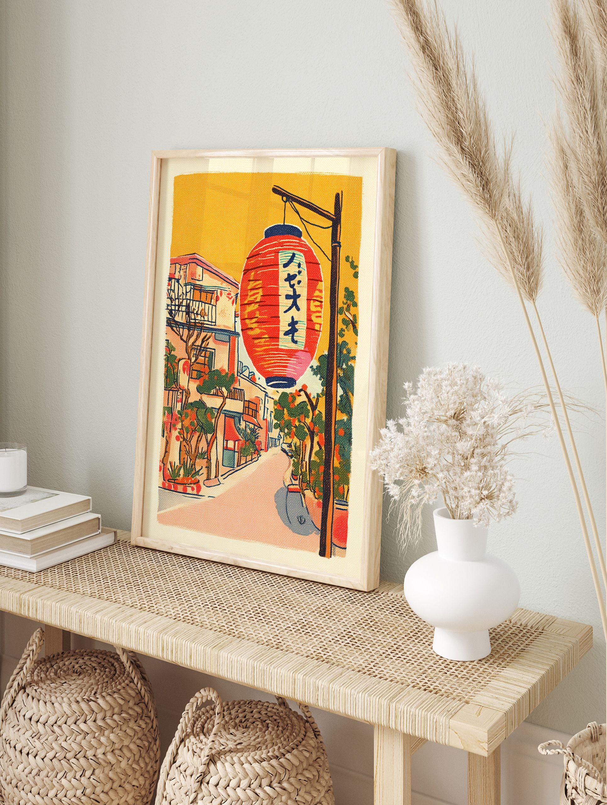 Illustrative Japanese street scene wall art with a large red lantern, traditional buildings, and green foliage under an orange sky. - Image 3