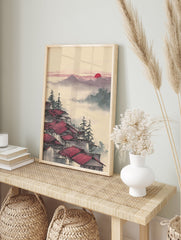 Japanese Wall Art print of red roof houses in misty mountains with pine trees and a red sun in the sky. - Image 3