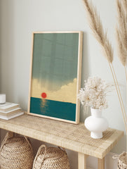 Japanese Wall Art print of a minimalist red sun setting over a calm blue ocean, with subtle clouds and a distant boat. - Image 3