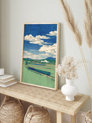 Japanese landscape wall art print with a train winding through green rice fields, mountains, and a blue sky with white clouds. - Image 3