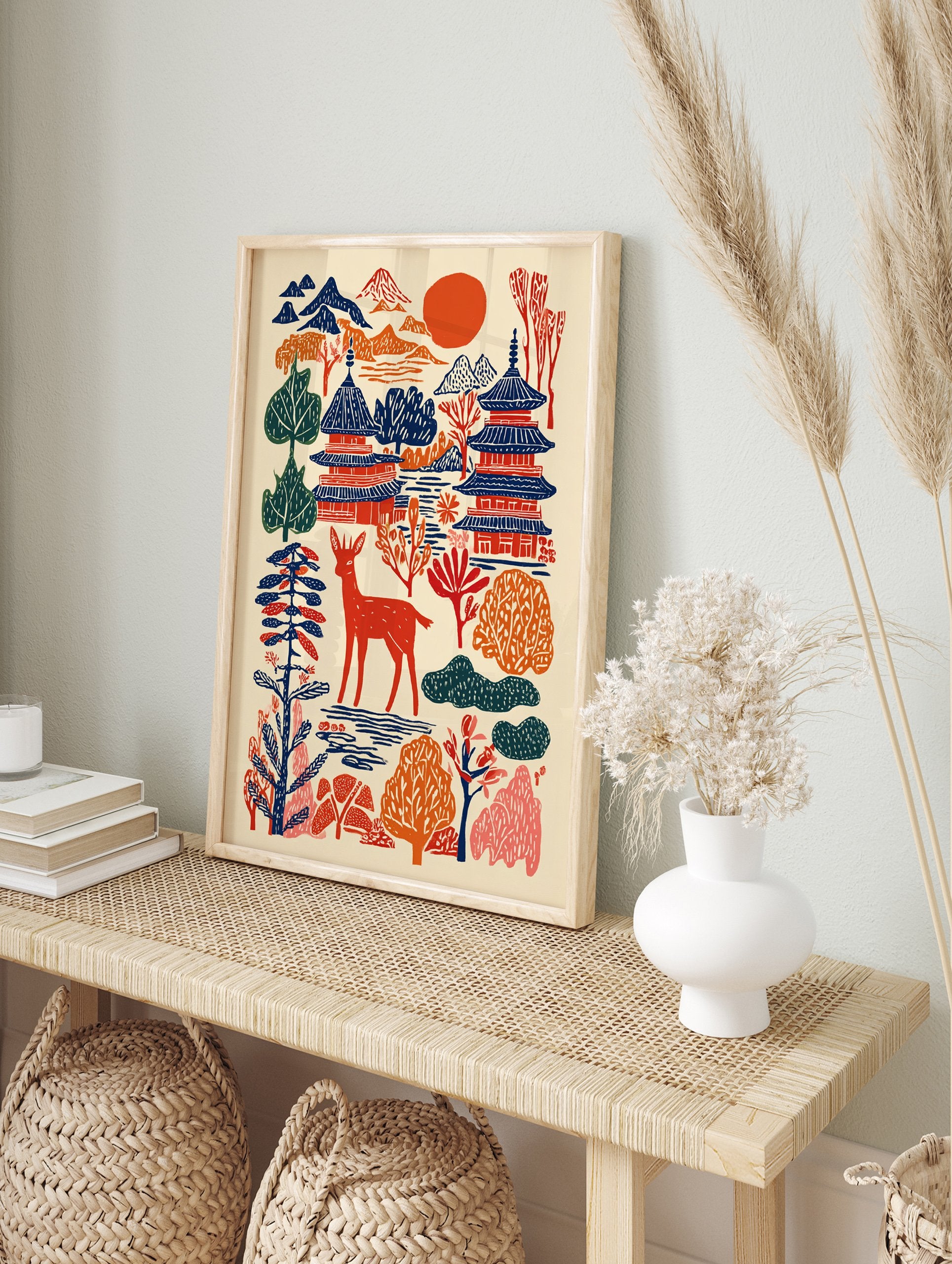Japanese wall art print with woodcut-style pagodas, mountains, a red deer, trees, and a red sun on a cream background. - Image 3