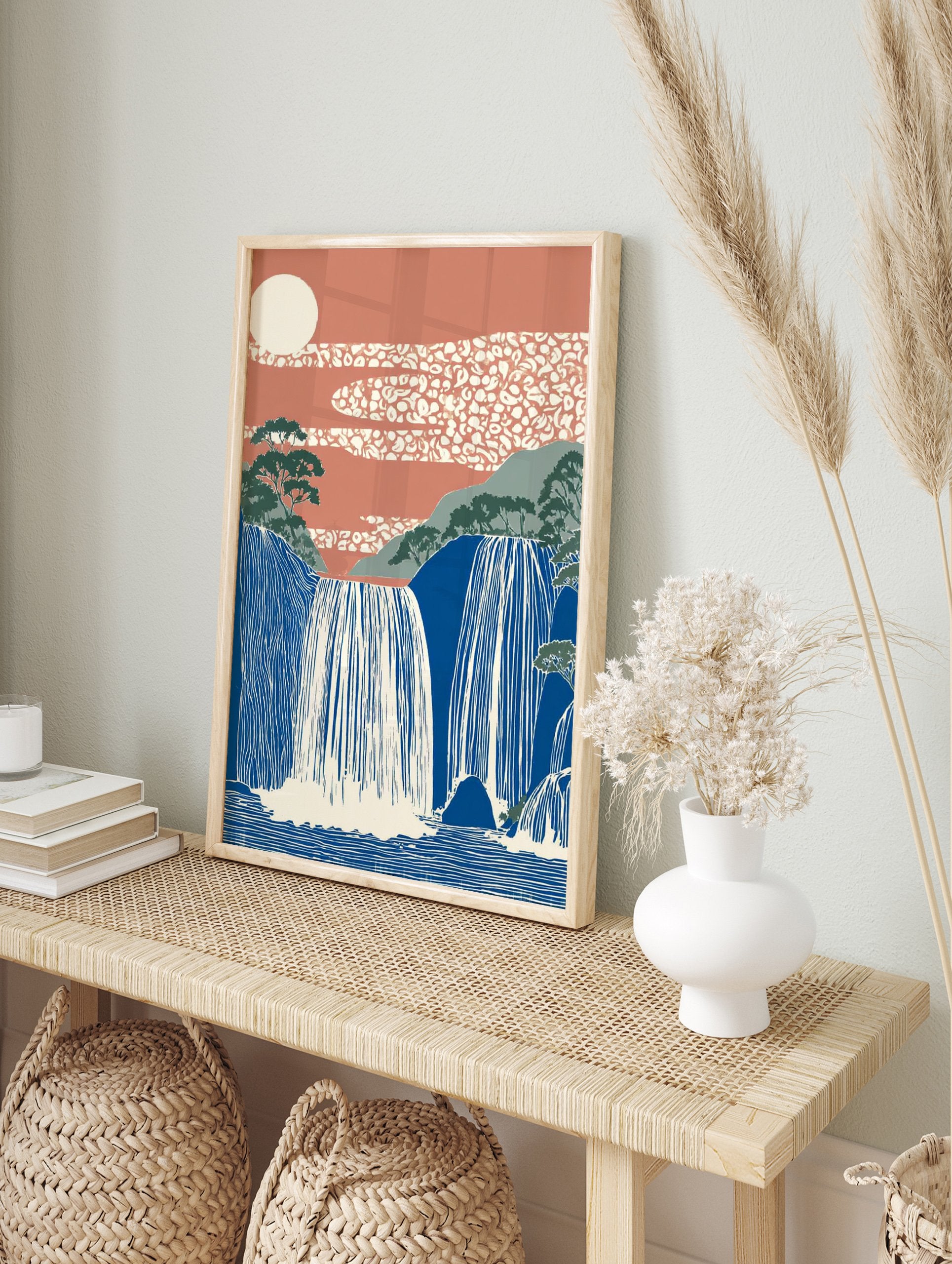 Japanese Waterfall Wall Art featuring blue cascading falls, green mountains, terracotta sky with patterned clouds and a cream sun. - Image 3
