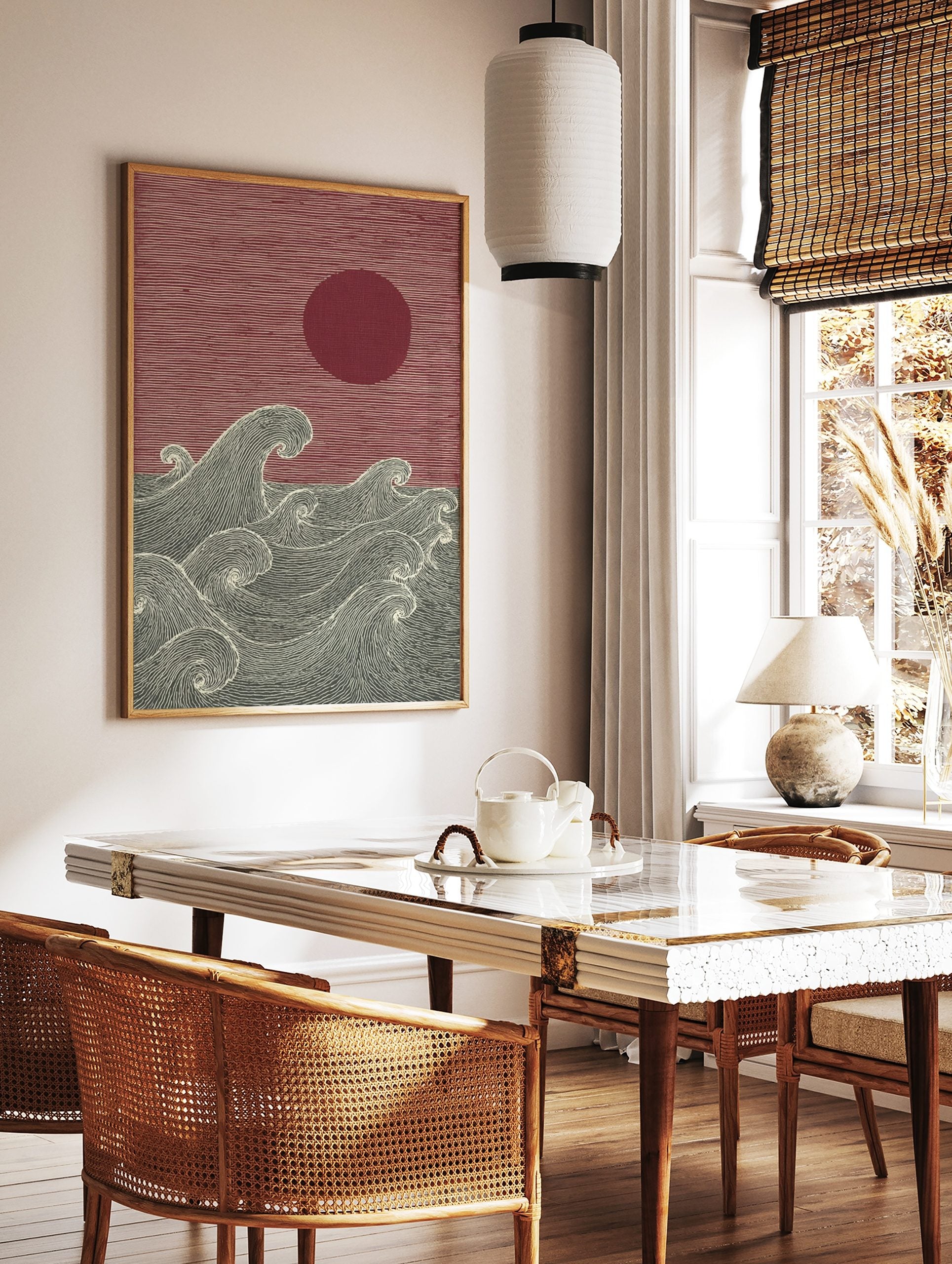 Japanese woodblock style art print with red sun and textured dark grey ocean waves, in a styled room mockup