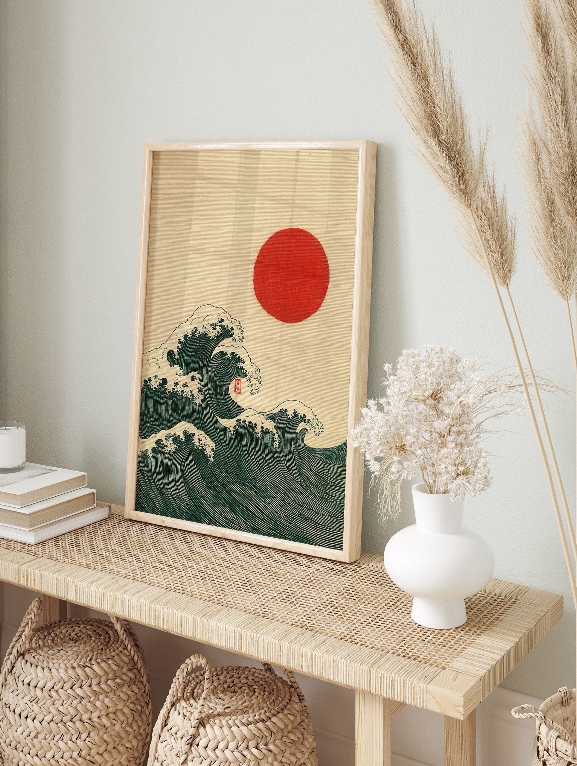 Japanese Ukiyo-e style art print of dark green ocean waves with white foam and a red sun, in an alternate framed mockup