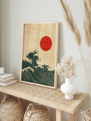 Japanese Ukiyo-e style art print of dark green ocean waves with white foam and a red sun, in an alternate framed mockup