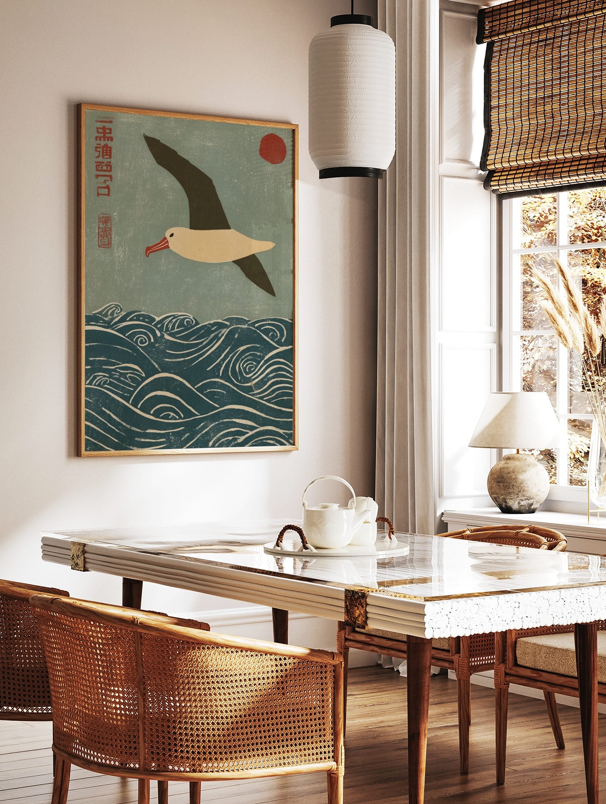 Japanese woodblock print of an albatross flying over blue waves with a red sun and kanji script, in a styled room mockup