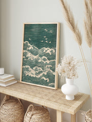 Japanese woodblock print of teal ocean waves with white foam and several white seagulls, in an alternate framed mockup