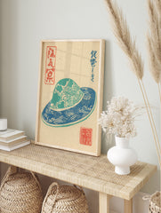 Traditional Japanese Woodblock Print depicting a blue and teal patterned hat with cultural characters on a beige background. - Image 3